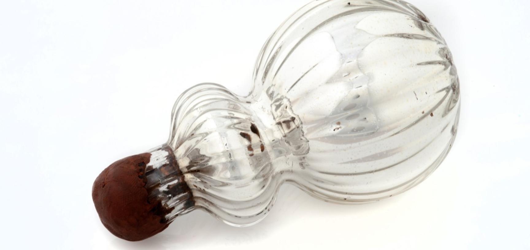 Small silver bottle with a wax stopper.