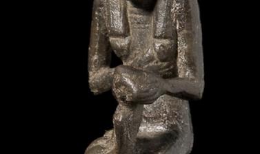 Small seated figure.