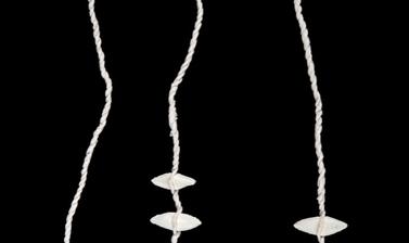 Long necklace made from small white parcel tags.